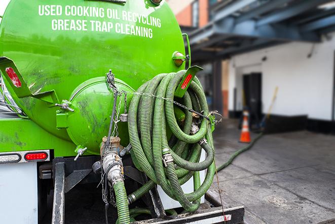 a grease trap being pumped by a sanitation technician in Mifflinburg, PA